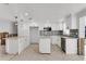 Bright white kitchen featuring stainless steel appliances, island with granite countertop, and mosaic tile backsplash at 5600 Bayou Grande Ne Blvd, St Petersburg, FL 33703