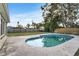 Relaxing backyard with a sparkling in-ground pool, well-maintained lawn, and privacy fence at 5600 Bayou Grande Ne Blvd, St Petersburg, FL 33703