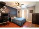 Guest bedroom with full-size bed, desk, and ceiling fan at 6516 Clair Shore Dr, Apollo Beach, FL 33572