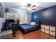 Cozy bedroom with a full-size bed, workspace, and dark blue walls at 6516 Clair Shore Dr, Apollo Beach, FL 33572