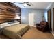 Large bedroom with wood-look floors and a rustic accent wall at 6516 Clair Shore Dr, Apollo Beach, FL 33572