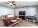 Spacious living room, leather couches, and a large TV at 6516 Clair Shore Dr, Apollo Beach, FL 33572