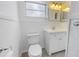 Simple bathroom with white vanity and toilet at 6623 16Th N St, St Petersburg, FL 33704