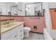 Retro bathroom with pink tile, a vanity, and a shower bathtub combo at 6623 16Th N St, St Petersburg, FL 33704