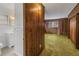 Bedroom with wood paneling and green carpet at 6623 16Th N St, St Petersburg, FL 33704