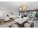 Open concept dining room with white table and chairs at 6623 16Th N St, St Petersburg, FL 33704