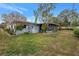 Ranch house with screened porch and a grassy yard at 6623 16Th N St, St Petersburg, FL 33704