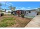 Side view of the house showing a screened porch and yard at 6623 16Th N St, St Petersburg, FL 33704