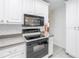 White kitchen with stainless steel appliances and subway tile backsplash at 6623 16Th N St, St Petersburg, FL 33704