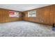 Living Room with wood paneled walls and gray carpet at 6623 16Th N St, St Petersburg, FL 33704