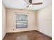 Small bedroom with wood floors and window at 6819 Stafford Rd, Plant City, FL 33565