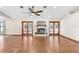 Spacious living room with hardwood floors, fireplace, and French doors at 6819 Stafford Rd, Plant City, FL 33565