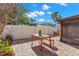 Brick patio with wooden table and chairs, surrounded by a white fence at 7262 55Th N Ave, St Petersburg, FL 33709