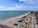 Drone shot of beach, showing pristine sand and ocean at 7466 Bayshore Dr # 406, Treasure Island, FL 33706