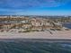 Aerial view of beachfront condo community with ocean and city views at 7466 Bayshore Dr # 406, Treasure Island, FL 33706