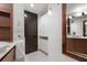 Guest bathroom with dark wood door and white cabinets at 7466 Bayshore Dr # 406, Treasure Island, FL 33706