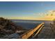 Wooden boardwalk leads to a beautiful beach at sunset at 7466 Bayshore Dr # 406, Treasure Island, FL 33706