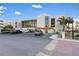 Condo building exterior showcasing parking and entrance at 7466 Bayshore Dr # 406, Treasure Island, FL 33706