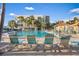 Community pool with lounge chairs and tropical landscaping at 7466 Bayshore Dr # 406, Treasure Island, FL 33706