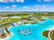 Aerial view of Crystal Lagoon, showing beach, water features, and surrounding landscape at 7853 Roma Dune Dr, Wesley Chapel, FL 33545