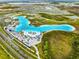 Aerial view of Crystal Lagoon amenity, beach, and surrounding community at 7853 Roma Dune Dr, Wesley Chapel, FL 33545