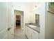 Simple bathroom with vanity, sink and view into bedroom at 7853 Roma Dune Dr, Wesley Chapel, FL 33545