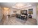 Elegant dining room with modern light fixture and gray chairs at 7853 Roma Dune Dr, Wesley Chapel, FL 33545