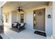 Front porch with seating area and neutral color scheme at 7853 Roma Dune Dr, Wesley Chapel, FL 33545