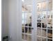 Home office with glass French doors and decorative mirrors at 7853 Roma Dune Dr, Wesley Chapel, FL 33545