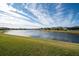 Peaceful lakefront view with homes and lush greenery at 7853 Roma Dune Dr, Wesley Chapel, FL 33545