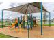 Community playground with shade structure and play equipment at 7853 Roma Dune Dr, Wesley Chapel, FL 33545