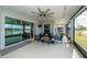 Serene screened porch with lake view and comfortable seating at 7853 Roma Dune Dr, Wesley Chapel, FL 33545