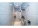 Spacious walk-in shower with dual shower heads and built-in shelving at 7853 Roma Dune Dr, Wesley Chapel, FL 33545