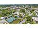 Aerial view of community with pool, tennis court, and buildings at 7975 58Th N Ave # 402, St Petersburg, FL 33709