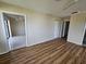 Bedroom with wood-look flooring and access to other rooms at 7975 58Th N Ave # 402, St Petersburg, FL 33709