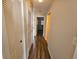 Hallway with wood-look floors and access to bedrooms and bathroom at 7975 58Th N Ave # 402, St Petersburg, FL 33709