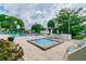 Community hot tub and pool area with lounge chairs at 7975 58Th N Ave # 402, St Petersburg, FL 33709