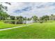 Landscaped pond with a fountain and benches at 7975 58Th N Ave # 402, St Petersburg, FL 33709