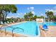 Community pool with plenty of lounge chairs for relaxing at 7975 58Th N Ave # 402, St Petersburg, FL 33709