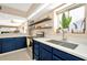 Modern kitchen with white countertops, blue cabinets, and a double sink at 813 Bahia Del Sol Dr # 33, Ruskin, FL 33570