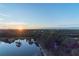 Sunset view of waterfront property with lush vegetation at 8186 Terrace Garden N Dr # 604, St Petersburg, FL 33709