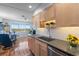 Modern kitchen featuring light wood cabinets, updated countertops, and a window with a view at 8186 Terrace Garden N Dr # 604, St Petersburg, FL 33709