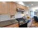 Stainless steel appliances and light wood cabinets in this updated kitchen at 8186 Terrace Garden N Dr # 604, St Petersburg, FL 33709