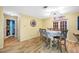 Dining area with gray table and chairs, hardwood floors, and french doors at 8296 15Th N Way, St Petersburg, FL 33702