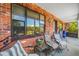 Relaxing front porch with striped chairs and a large blue pot at 8296 15Th N Way, St Petersburg, FL 33702