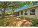 Ranch-style home with screened porch and landscaped yard at 8296 15Th N Way, St Petersburg, FL 33702