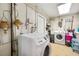 Bright laundry room with washer, dryer, and ample storage at 8296 15Th N Way, St Petersburg, FL 33702