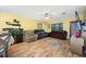 Bright living room with hardwood floors, leather furniture, and a large TV at 8296 15Th N Way, St Petersburg, FL 33702