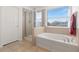 Bathroom with soaking tub and walk-in shower at 8919 N River Rd, Tampa, FL 33635