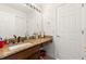 Bathroom with granite countertop, wood cabinets, and updated fixtures at 8919 N River Rd, Tampa, FL 33635